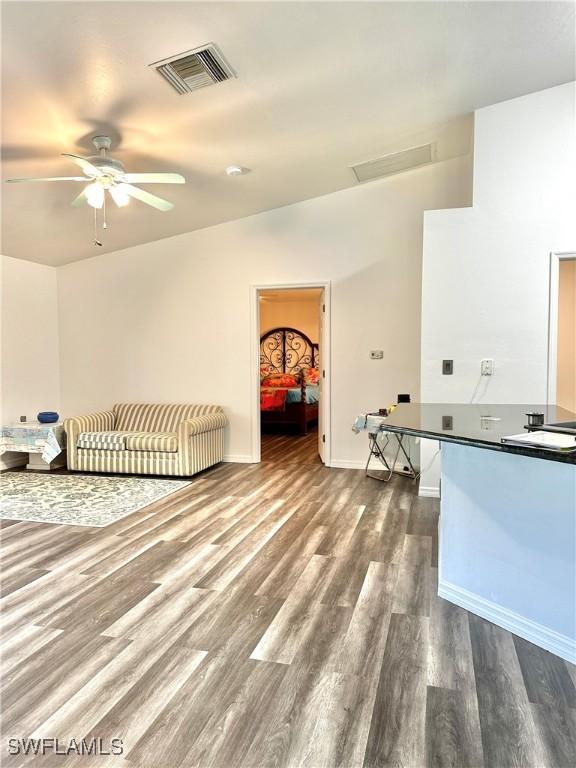 2675 70th Ave NE, Naples, FL 34120 - unfurnished bedroom featuring dark wood-style floors and attic access