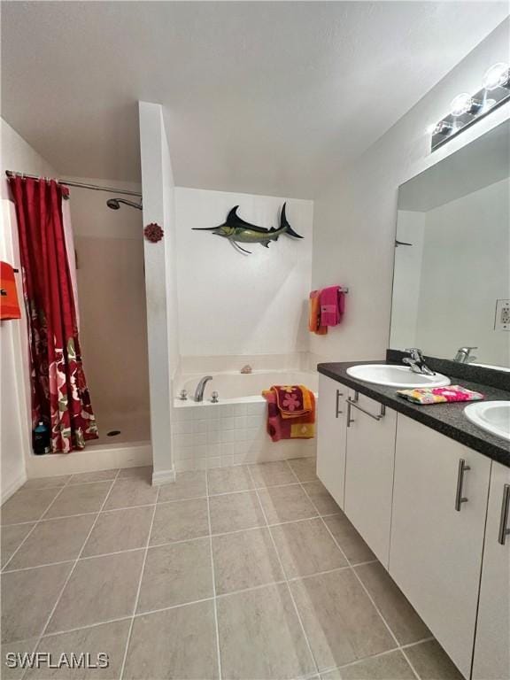 2675 70th Ave NE, Naples, FL 34120 - full bathroom featuring tile patterned flooring, a garden tub, double vanity, and a stall shower