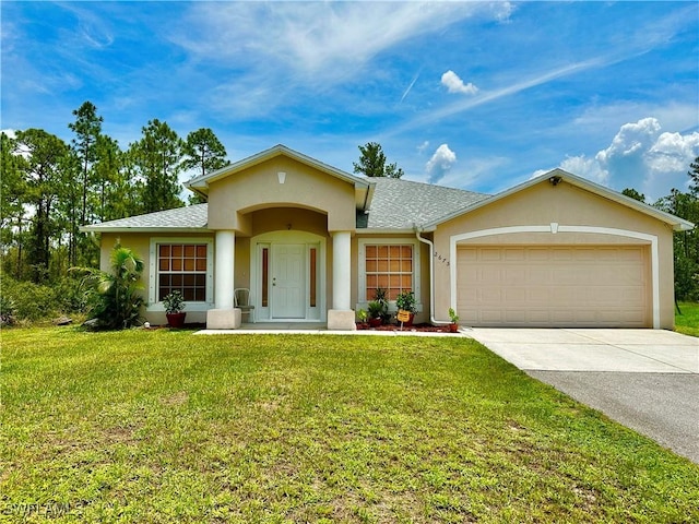 2675 70th Ave NE, Naples, FL 34120 - view of front of property with stucco siding, concrete driveway, an attached garage, a front yard, and a shingled roof