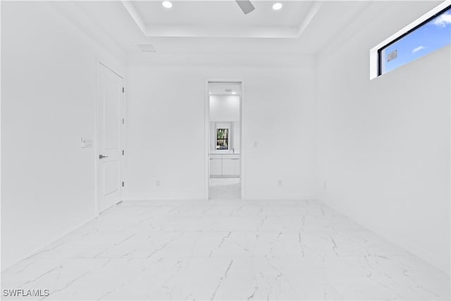 2601 Karen Cir, Lehigh Acres, FL 33971 - unfurnished room featuring a raised ceiling, light marble finish flooring, and recessed lighting