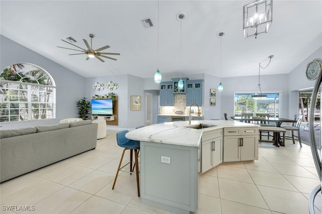 4404 SW 5th Ave, Cape Coral, FL 33914 - kitchen featuring lofted ceiling, light tile patterned flooring, a ceiling fan, open floor plan, and pendant lighting