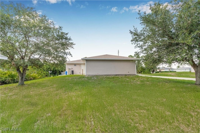 2818 66th St W, Lehigh Acres, FL 33971 - view of property exterior featuring a lawn