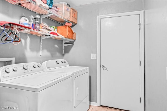 2818 66th St W, Lehigh Acres, FL 33971 - laundry room featuring washer and clothes dryer and light tile patterned floors
