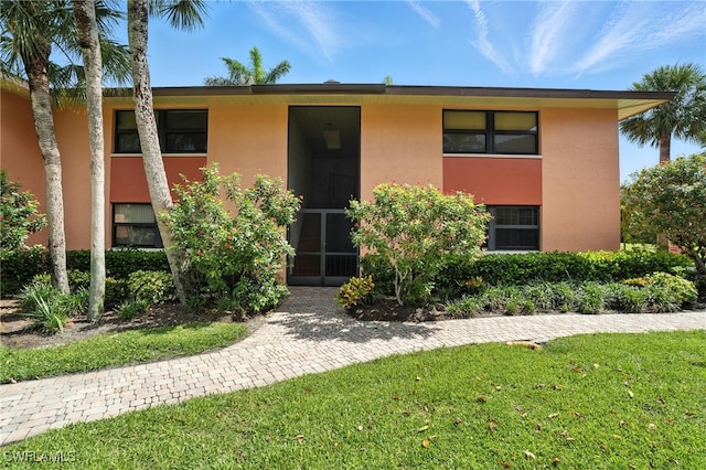 1506 Mainsail Dr Unit 1, Naples, FL 34114 - view of property featuring stucco siding and a front yard
