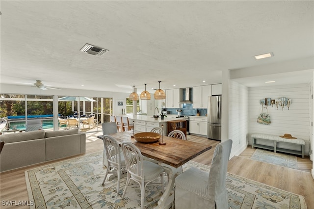 486 Lake Murex Cir, Sanibel, FL 33957 - dining area featuring ceiling fan, light wood-style floors, and a textured ceiling