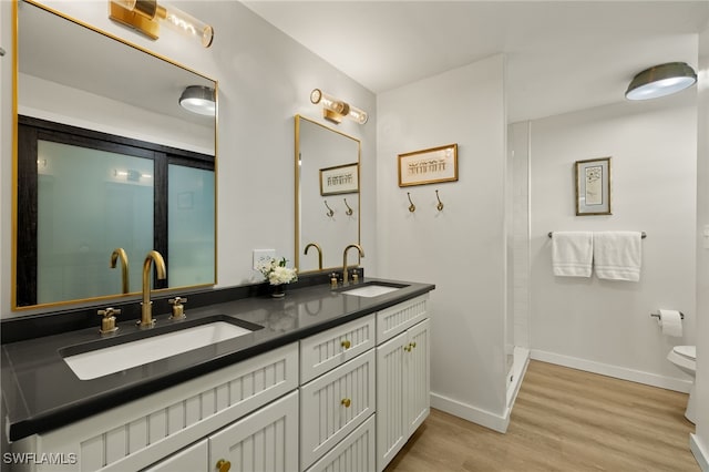 486 Lake Murex Cir, Sanibel, FL 33957 - bathroom featuring double vanity, wood finished floors, and a shower