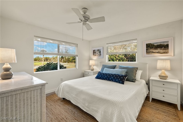 486 Lake Murex Cir, Sanibel, FL 33957 - bedroom featuring multiple windows, wood finished floors, and a ceiling fan