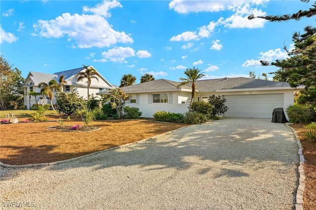 486 Lake Murex Cir, Sanibel, FL 33957 - ranch-style home with gravel driveway, a garage, and stucco siding
