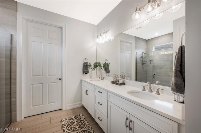 374 Deauville Loop, Naples, FL 34114 - full bathroom with double vanity, a stall shower, and wood finished floors