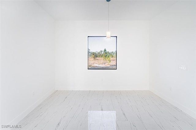 1268 Hillcrest St E, Lehigh Acres, FL 33974 - empty room featuring marble look tiles and baseboards