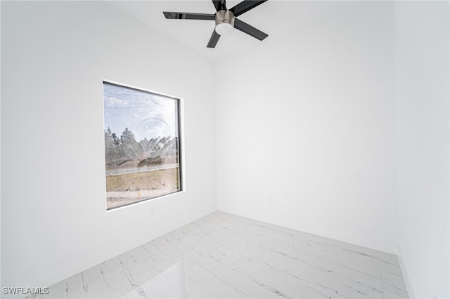 1268 Hillcrest St E, Lehigh Acres, FL 33974 - empty room featuring marble look tiles and a ceiling fan