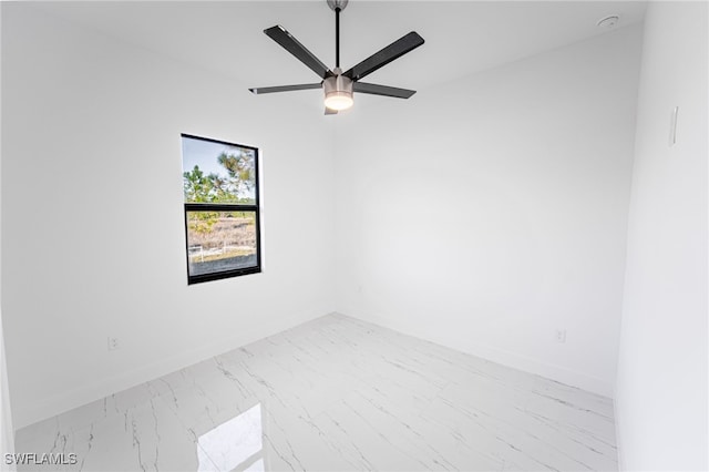 1268 Hillcrest St E, Lehigh Acres, FL 33974 - unfurnished room featuring marble look tile flooring, ceiling fan, and a smoke detector