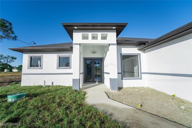 1268 Hillcrest St E, Lehigh Acres, FL 33974 - doorway to property with stucco siding and roof with shingles