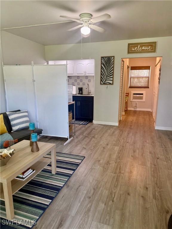 240 N Collier Blvd Unit A3, Marco Island, FL 34145 - living room with light wood finished floors and a ceiling fan