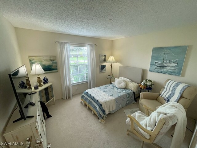 6300 S Pointe Blvd Unit 459, Fort Myers, FL 33919 - bedroom featuring light carpet and a textured ceiling