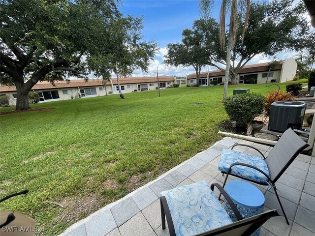 6300 S Pointe Blvd Unit 459, Fort Myers, FL 33919 - view of grassy yard featuring a residential view and a patio area