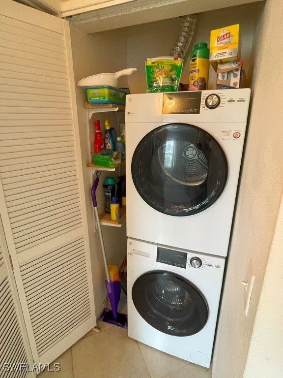 6300 S Pointe Blvd Unit 459, Fort Myers, FL 33919 - washroom featuring stacked washer / dryer and light tile patterned floors