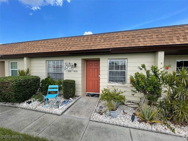6300 S Pointe Blvd Unit 459, Fort Myers, FL 33919 - view of exterior entry featuring a shingled roof and mansard roof