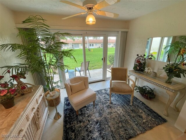 6300 S Pointe Blvd Unit 459, Fort Myers, FL 33919 - living area featuring tile patterned flooring, a ceiling fan, and a textured ceiling