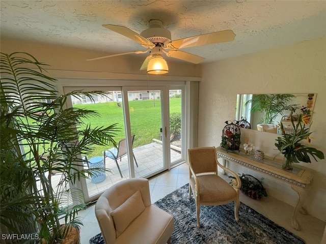 6300 S Pointe Blvd Unit 459, Fort Myers, FL 33919 - living area featuring light tile patterned floors, a textured ceiling, and ceiling fan