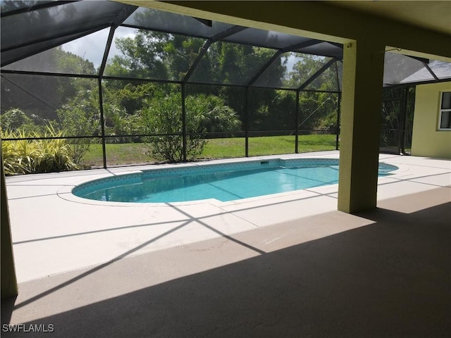 23447 Olde Meadowbrook Cir, Estero, FL 34134 - swimming pool with a patio area and glass enclosure