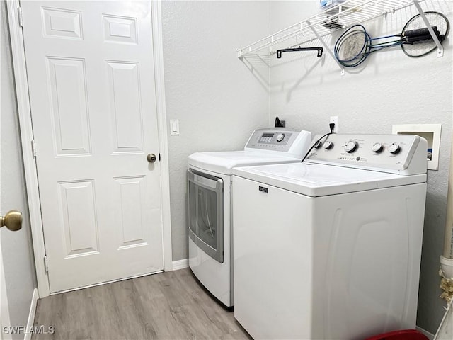 23447 Olde Meadowbrook Cir, Estero, FL 34134 - laundry area featuring independent washer and dryer and light wood finished floors