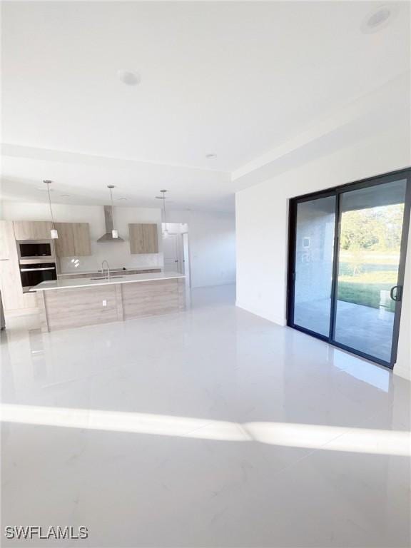 14121 Carlos St, Fort Myers, FL 33905 - kitchen featuring modern cabinets, appliances with stainless steel finishes, wall chimney exhaust hood, light countertops, and pendant lighting