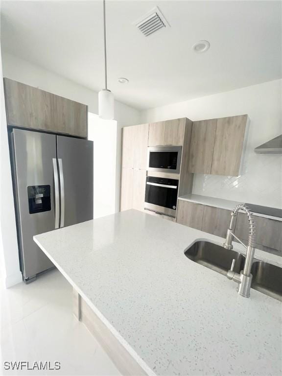 14121 Carlos St, Fort Myers, FL 33905 - kitchen featuring stainless steel appliances, modern cabinets, hanging light fixtures, light brown cabinets, and recessed lighting