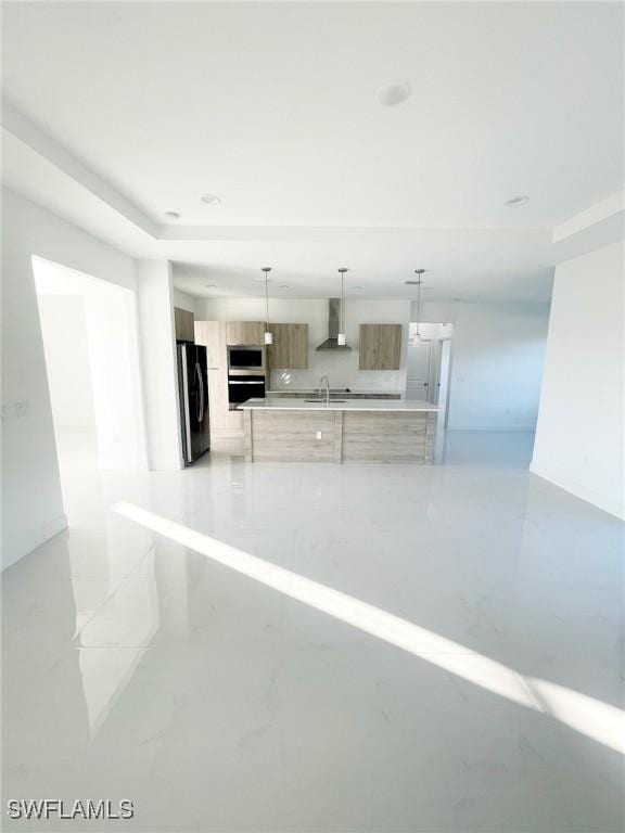 14121 Carlos St, Fort Myers, FL 33905 - kitchen featuring appliances with stainless steel finishes, wall chimney exhaust hood, modern cabinets, light countertops, and hanging light fixtures