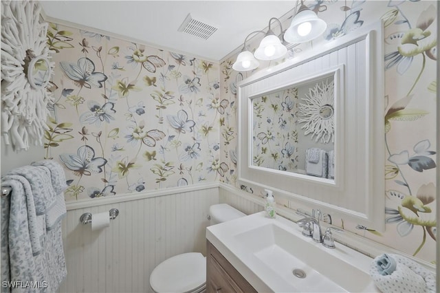 18068 San Carlos Blvd Unit 515, Fort Myers Beach, FL 33931 - half bathroom featuring wallpapered walls, wainscoting, and vanity