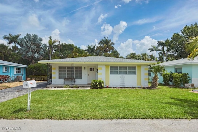 1721 Smugglers Cv, Naples, FL 34112 - ranch-style home featuring a front yard, covered porch, and gravel driveway