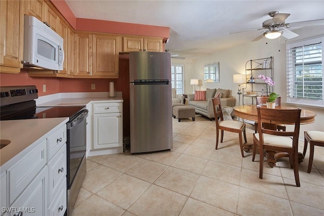 1721 Smugglers Cv, Naples, FL 34112 - kitchen featuring stainless steel appliances, light countertops, light tile patterned floors, ceiling fan, and open floor plan