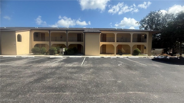 606 Gerald Ave Unit 115, Lehigh Acres, FL 33936 - view of building exterior featuring uncovered parking