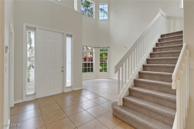 8677 Pegasus Dr, Lehigh Acres, FL 33971 - tiled foyer entrance with plenty of natural light, a high ceiling, and stairway