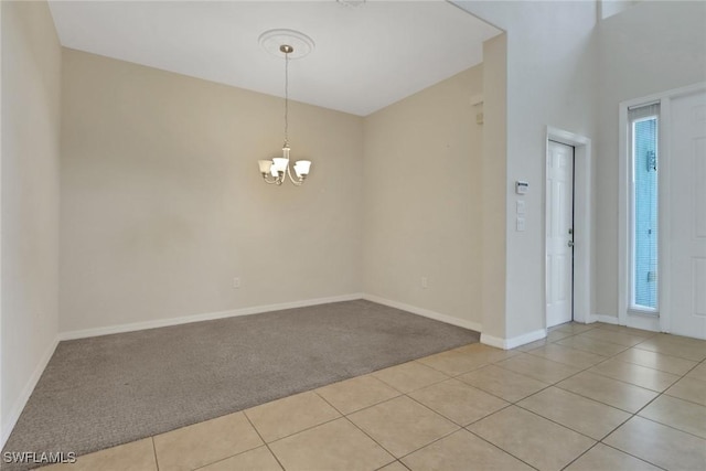 8677 Pegasus Dr, Lehigh Acres, FL 33971 - unfurnished room featuring light carpet, a chandelier, and light tile patterned floors