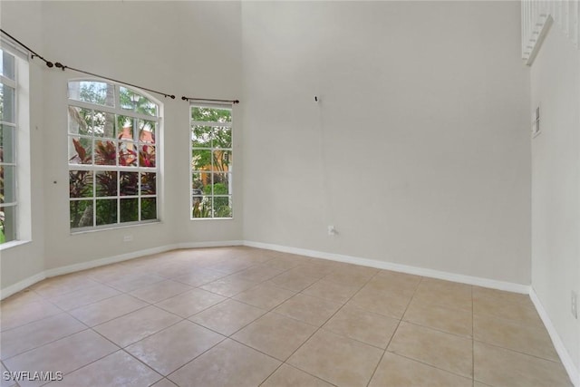 8677 Pegasus Dr, Lehigh Acres, FL 33971 - unfurnished room featuring light tile patterned flooring and a high ceiling