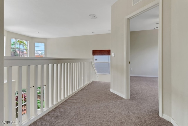 8677 Pegasus Dr, Lehigh Acres, FL 33971 - corridor featuring carpet flooring and baseboards