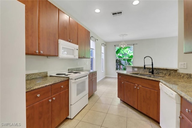 8677 Pegasus Dr, Lehigh Acres, FL 33971 - kitchen with white appliances, a peninsula, light tile patterned floors, light stone countertops, and recessed lighting