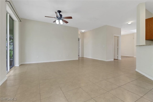 8677 Pegasus Dr, Lehigh Acres, FL 33971 - empty room featuring a ceiling fan and light tile patterned flooring