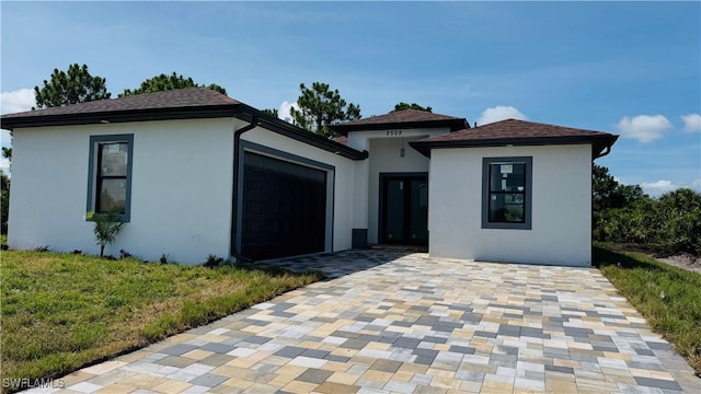 2503 46th St SW, Lehigh Acres, FL 33976 - view of front facade featuring stucco siding, an attached garage, and a front lawn