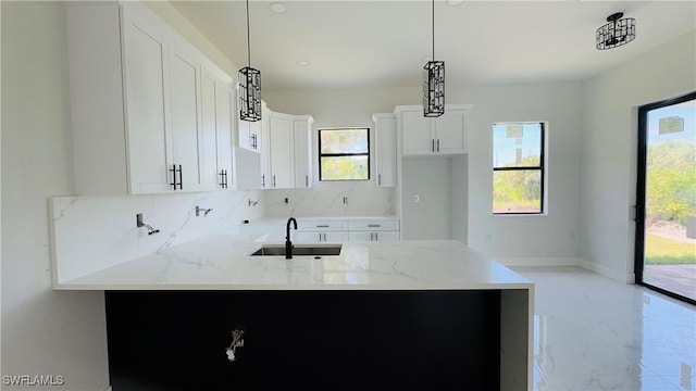 2503 46th St SW, Lehigh Acres, FL 33976 - kitchen featuring plenty of natural light, backsplash, light stone counters, and light marble finish flooring