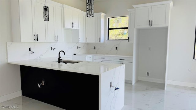 2503 46th St SW, Lehigh Acres, FL 33976 - kitchen with light marble finish flooring, backsplash, light stone counters, and white cabinets