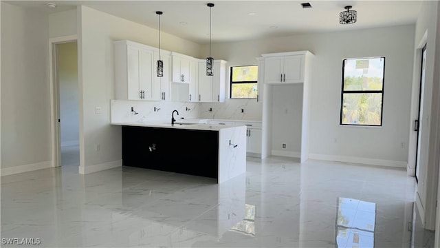 2503 46th St SW, Lehigh Acres, FL 33976 - kitchen featuring decorative backsplash, white cabinetry, light marble finish floors, decorative light fixtures, and light countertops