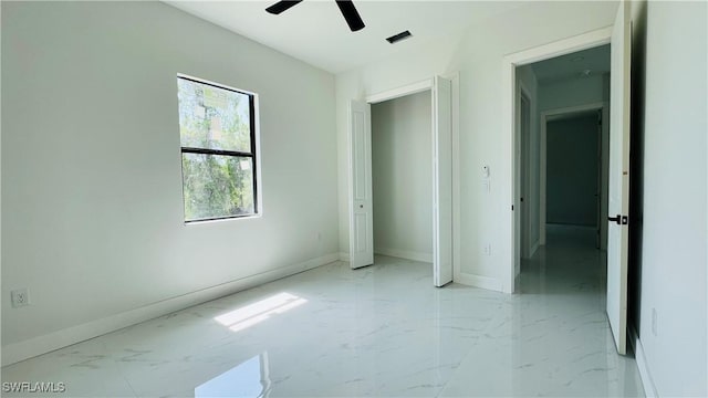 2503 46th St SW, Lehigh Acres, FL 33976 - unfurnished bedroom with light marble finish flooring and ceiling fan