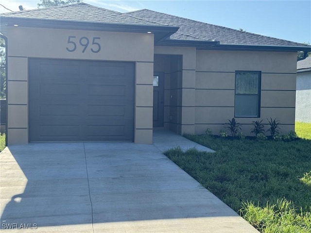 595 Carolina Ave, Fort Myers, FL 33905 - ranch-style home featuring concrete driveway, roof with shingles, stucco siding, an attached garage, and a front yard