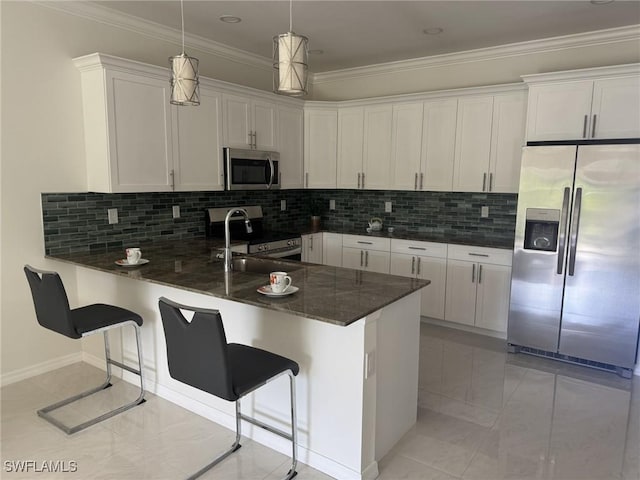 595 Carolina Ave, Fort Myers, FL 33905 - kitchen with stainless steel appliances, a peninsula, white cabinetry, decorative backsplash, and crown molding