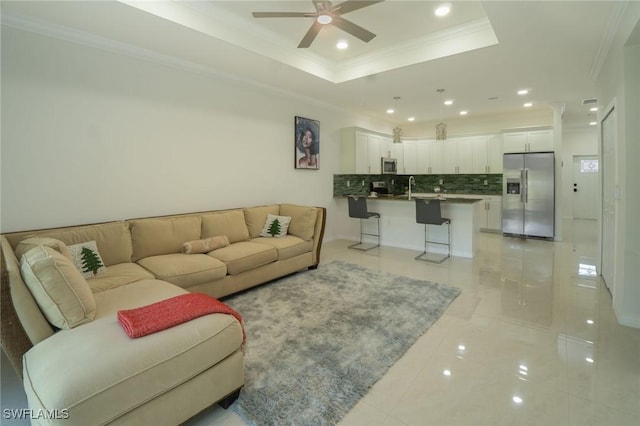 595 Carolina Ave, Fort Myers, FL 33905 - living room featuring crown molding, light tile patterned floors, ceiling fan, recessed lighting, and a tray ceiling