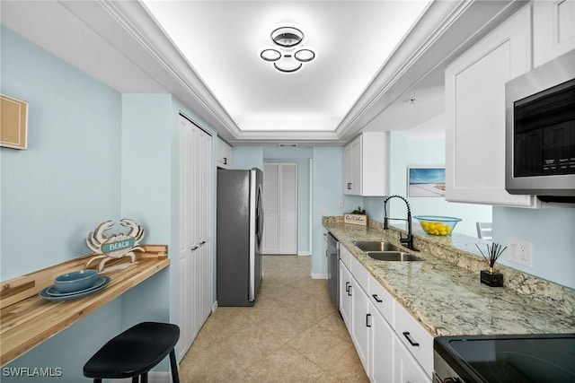 4411 Bay Beach Ln Unit 744, Fort Myers Beach, FL 33931 - kitchen with appliances with stainless steel finishes, white cabinetry, light stone countertops, a raised ceiling, and light tile patterned flooring