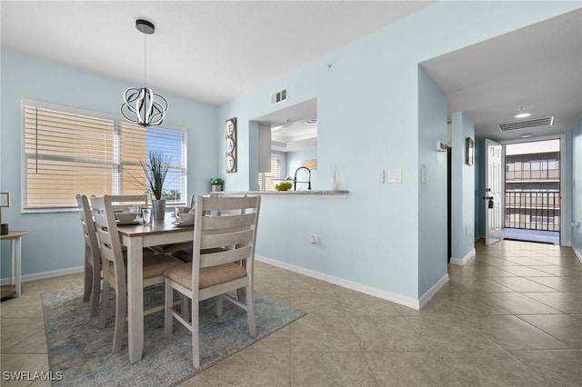 4411 Bay Beach Ln Unit 744, Fort Myers Beach, FL 33931 - tiled dining room with plenty of natural light and a chandelier