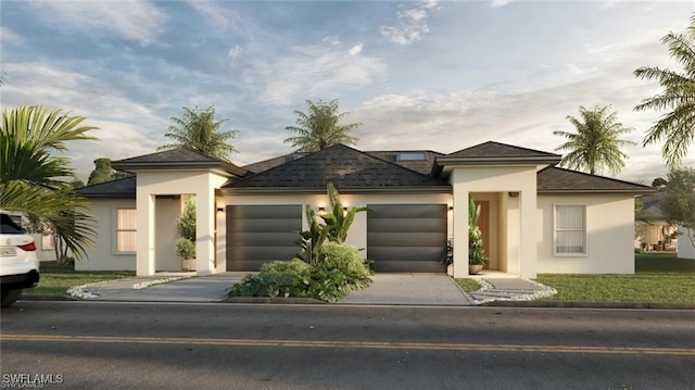 918 Eisenhower Blvd, Lehigh Acres, FL 33974 - prairie-style house featuring an attached garage, concrete driveway, stucco siding, and roof with shingles